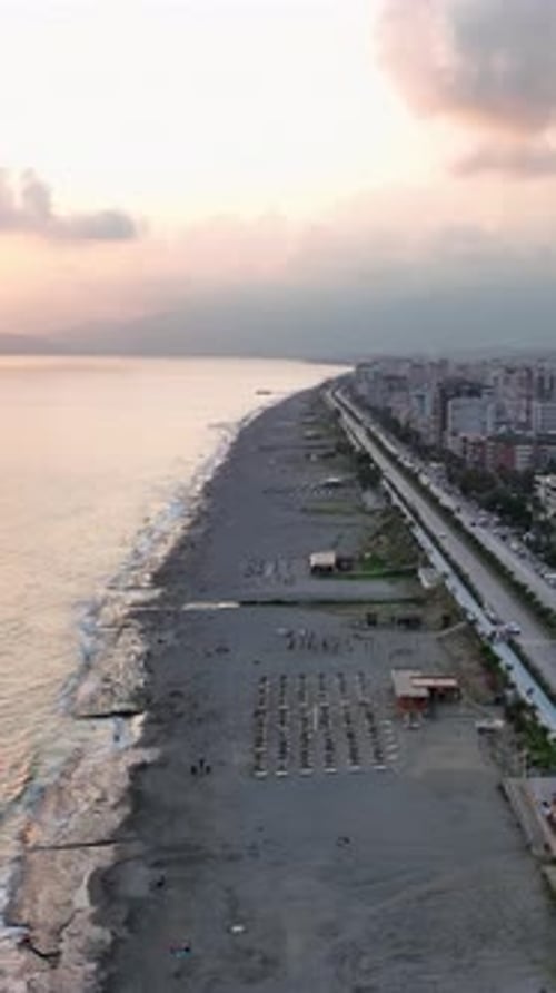 Vertical Video Stunning Sea Texture with Foamy Waves Hitting a Rocky Beach on a Calm Day