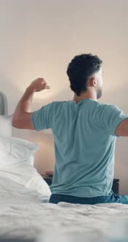 Back, stretching and wake up with man in bedroom of home for start of day or morning on weekend