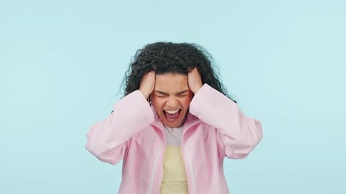Woman, screaming and stress, mental health and frustrated with life crisis isolated on blue