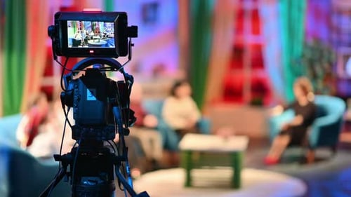 Professional television camera shooting a talk show in a studio. Video production backstage