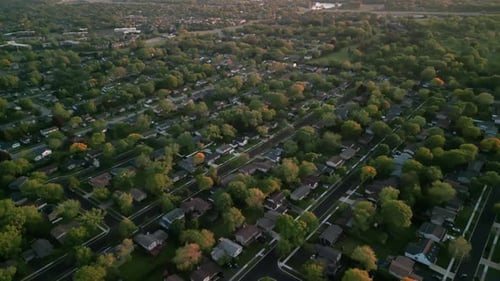 Above Aerial View of Colorful Trees Residential Houses and Yards Near City Wide Shot Footage