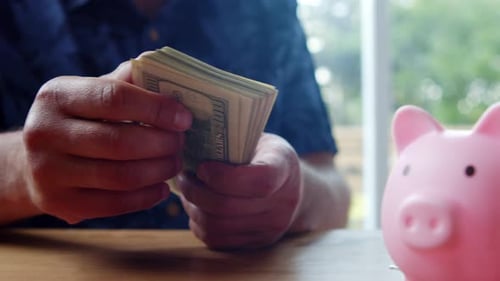 Close Up Of Money Counting Scene With Hands And Bills On Kitchen Table