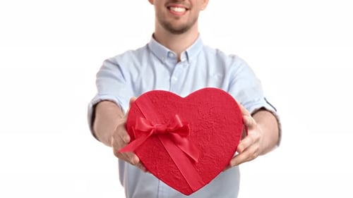 Unrecognizable Man Giving Red Gift Box Heart Shape Valentine's Day Birthday Celebrate Closeup