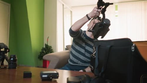 Man Reaching Into Camera Equipment Bag for Microphone in Bright