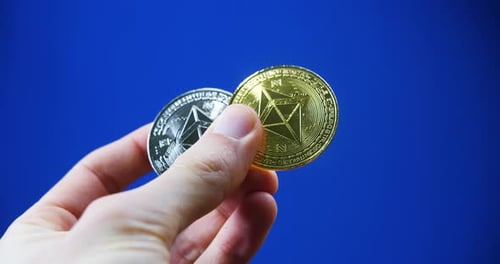 business investor hand holding crypto silver and gold coins cryptocurrency digital currency ethereum