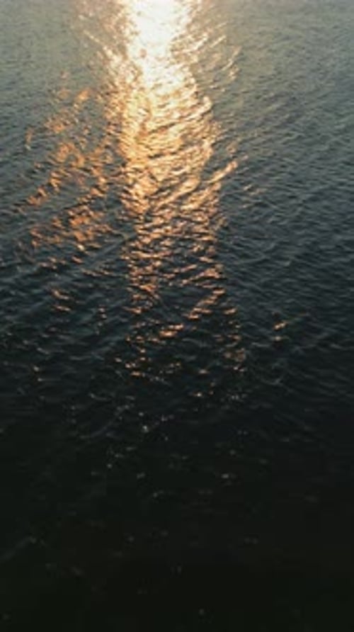 Aerial View of the Blue Surface of the Sea or Ocean at Sunset