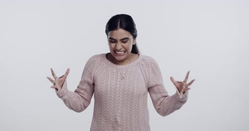 Woman, frustrated or angry with stress in studio, conflict or fight on white background