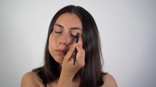 Young Woman Applying Eyeshadow Makeup 4K