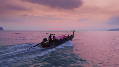 Witness the Stunning Sunset Over Krabi Thailand Aerial View Showcasing LongTail Boat
