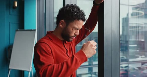 Frustrated businessman, headache and window with stress for company bankruptcy