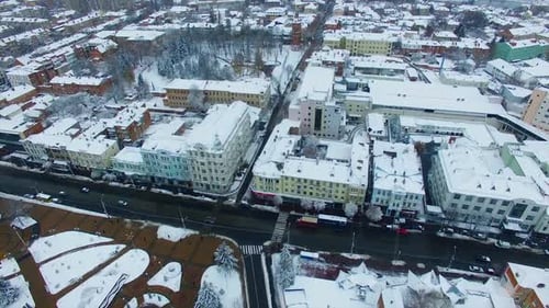 Snowy roofs of the buildings in the city downtown. Beautiful view of the urban landscape