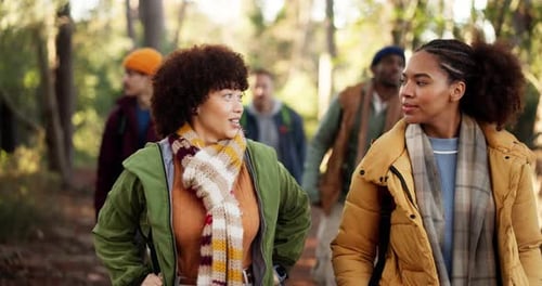 Hiking, talking and friends with walking in forest for travel adventure, explore nature or wellness