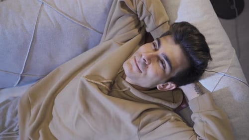 Man daydreaming, smiling thinking good things.