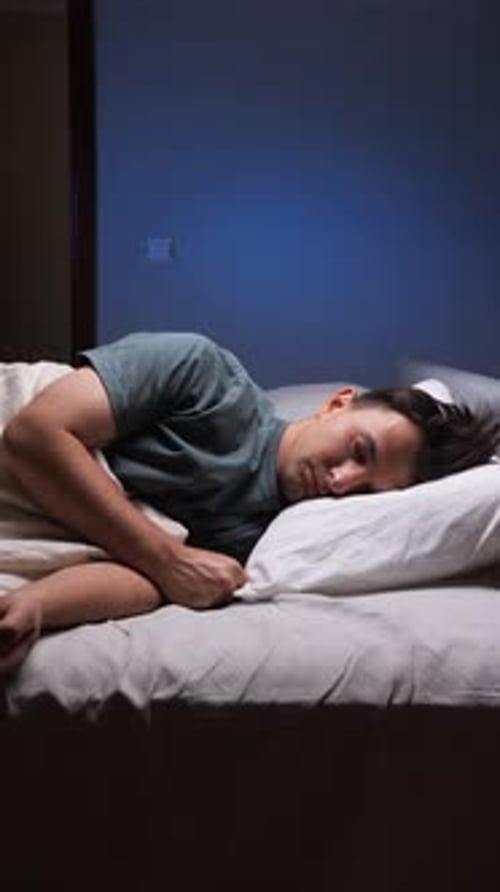 Vertical Video Man Sleeping Peacefully in Bed at Night Man Enjoys a Deep Restful Sleep