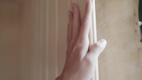 Hand glides over the planks and wooden surface