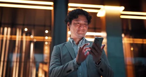 City, phone and Asian businessman at night for social media, communication and online chat