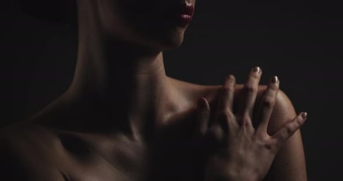 Hand, shoulder and skincare with woman on black background for aesthetic dermatology or cosmetics