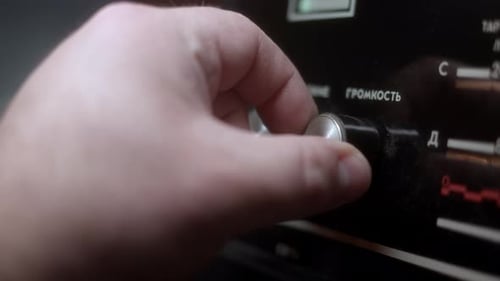 Man Hand Turn Volume on Old Vintage Radioll Made in USSR Inscriptions in Russian VOLUME