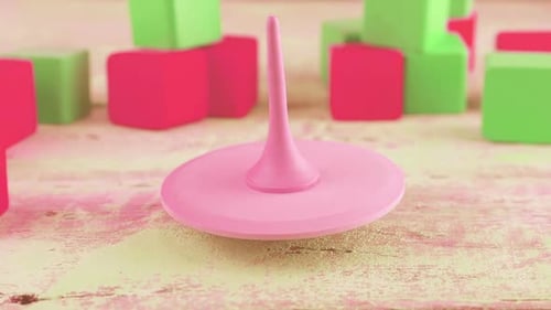 Peg toy or whirligig rotates on a vintage wooden board against the background of toy blocks.