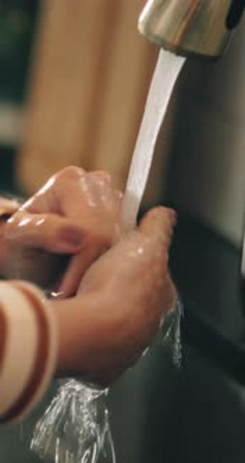 Person, hands and washing with water for hygiene, disinfection or rinse in kitchen sink at home