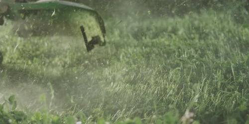 Lawn mower trimming grass