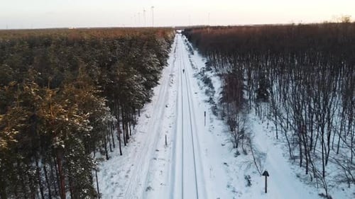 Someone walking on the train rail.