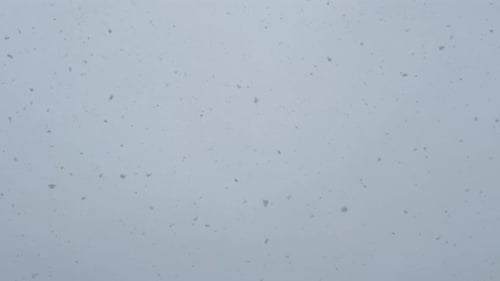 Snowfall on a White Surface Creates a Serene Misty Event in the Sky
