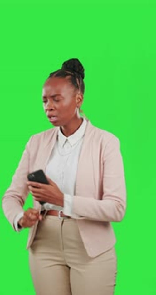 Phone, anger and a frustrated black woman on a green screen background in studio feeling upset