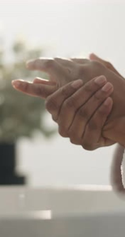 Hygiene, water and person washing hands in bathroom for soap, health or wellness in home