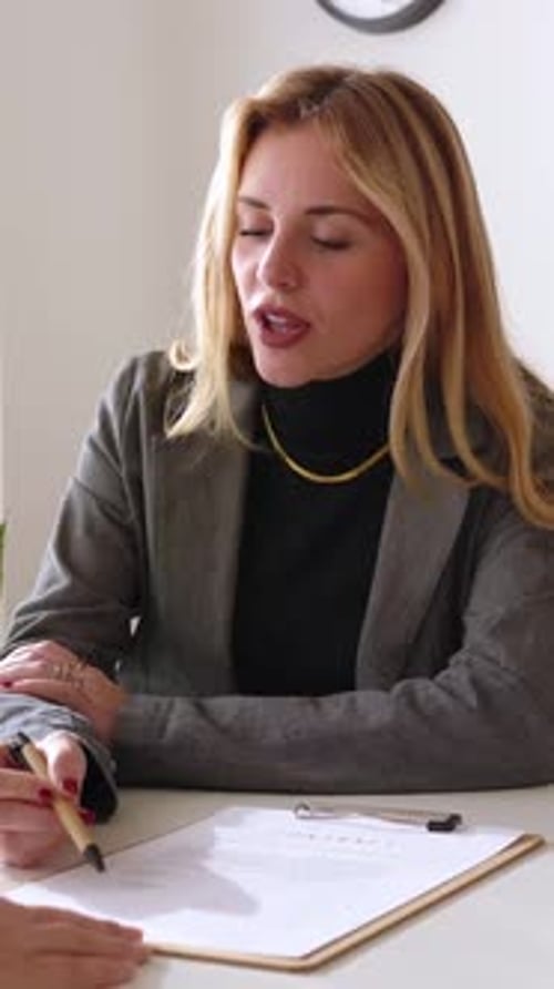 Mature Businesswoman Signing Contract Letter with Pen