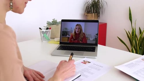 Female HR Recruiter Talking with Job Applicant By Laptop Video Call at Office