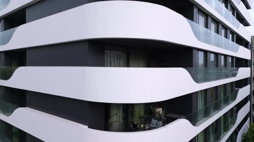 Aerial View of a Drone Flying Around and Along the Facade of a Modern Residential Building