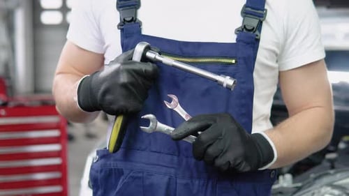 Car Mechanic in Garage with Tools