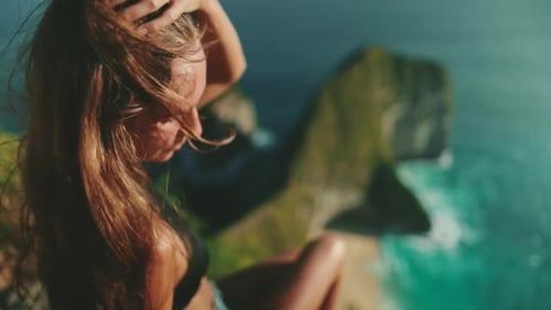 Woman with Long Hair Sitting on Cliff Bali Island