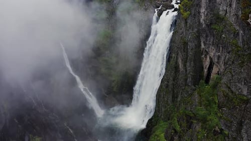 Voringfossen Waterfall and Sorrounding Valley in Rainy and Fogy Typical Norway Weather Captured By