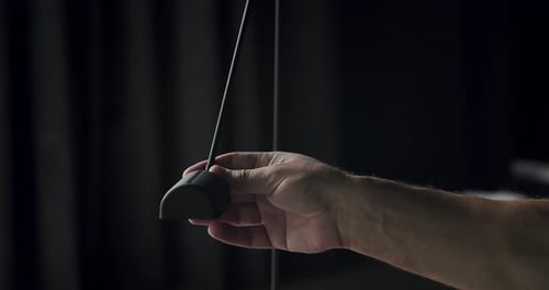 A Man is Sitting on the Gray Fabric Sofa and Correct Black Modern Light Lamp