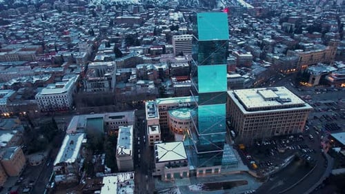 Glass Skyscraper In The Snowy City