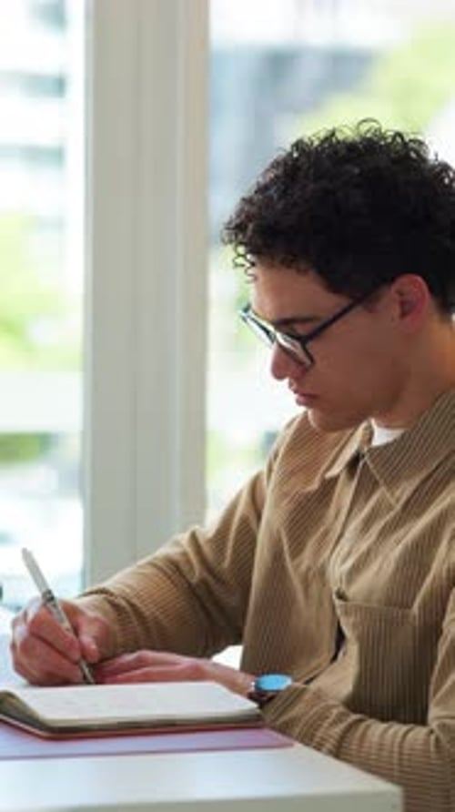 Education, student and writing with pen in notebook for course, learning knowledge