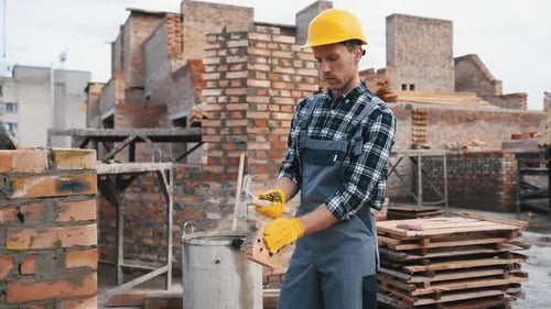 Construction worker in uniform and safety equipment have job on building