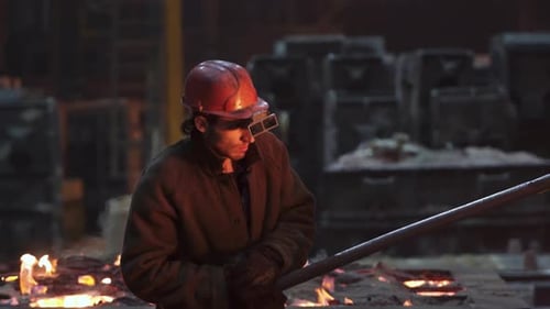 A Diligent Worker in a Metal Foundry is Equipped with Protective Gear for Safety Stock Clip
