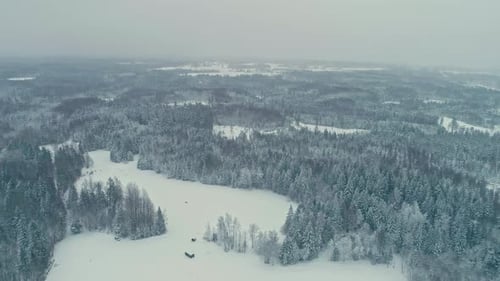 White Snowy Winter Landscape in Rural Countryside, High Rise Aerial View of Snow Capped Land and For