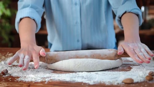 Professional Male Baker Rolling Out Dough for Bread or Pasta on Table Closeup View of Hands Bakery