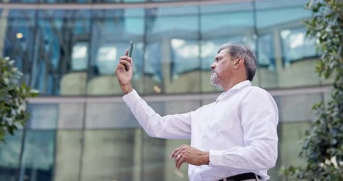 Man, phone and no service outdoor in city while searching for signal or connection for a call