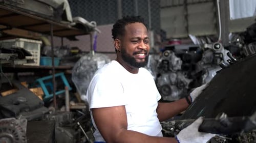 Men repairing car engine in auto repair shop, Selective focus.