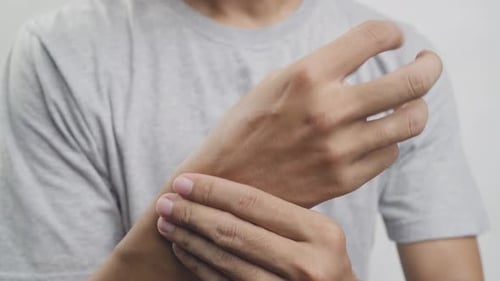 A man feels pain in his wrist