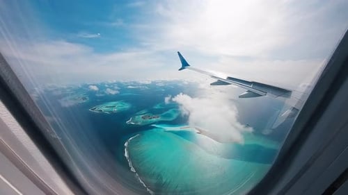 Airplane Flies Over the Islands in the Maldives