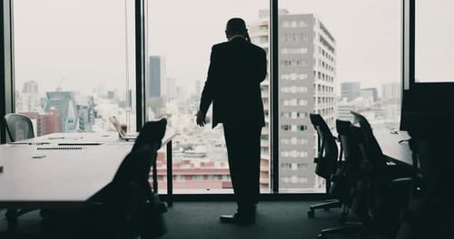 Phone call, anger and man at window in office with anxiety debt and bankruptcy in city in Japan