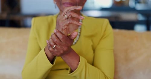 Hands, pain and senior woman on sofa with arthritis stress, disaster or muscle