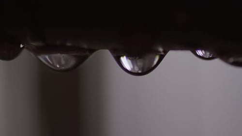 Water Droplet Leaking from Plumbing Metal Pipe, Extreme Closeup