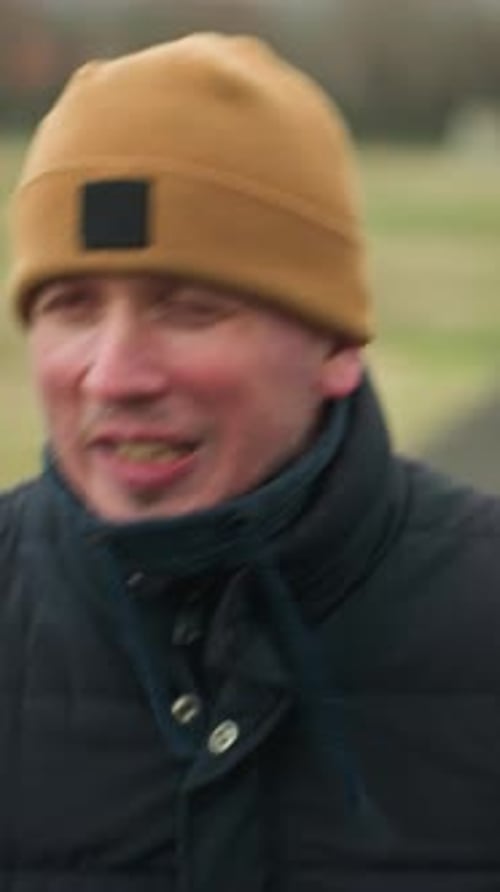 Coach Jogging on Track in Stadium Talking to Himself Blurred Background
